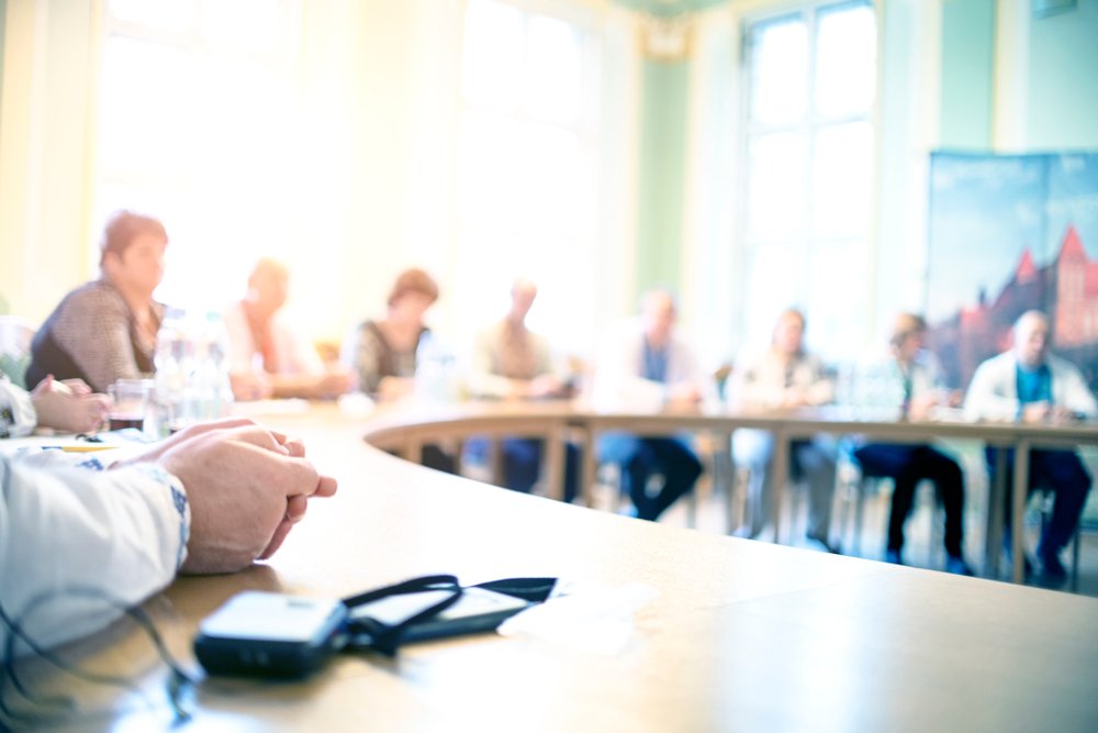 Photograph of board of directors sitting at board table