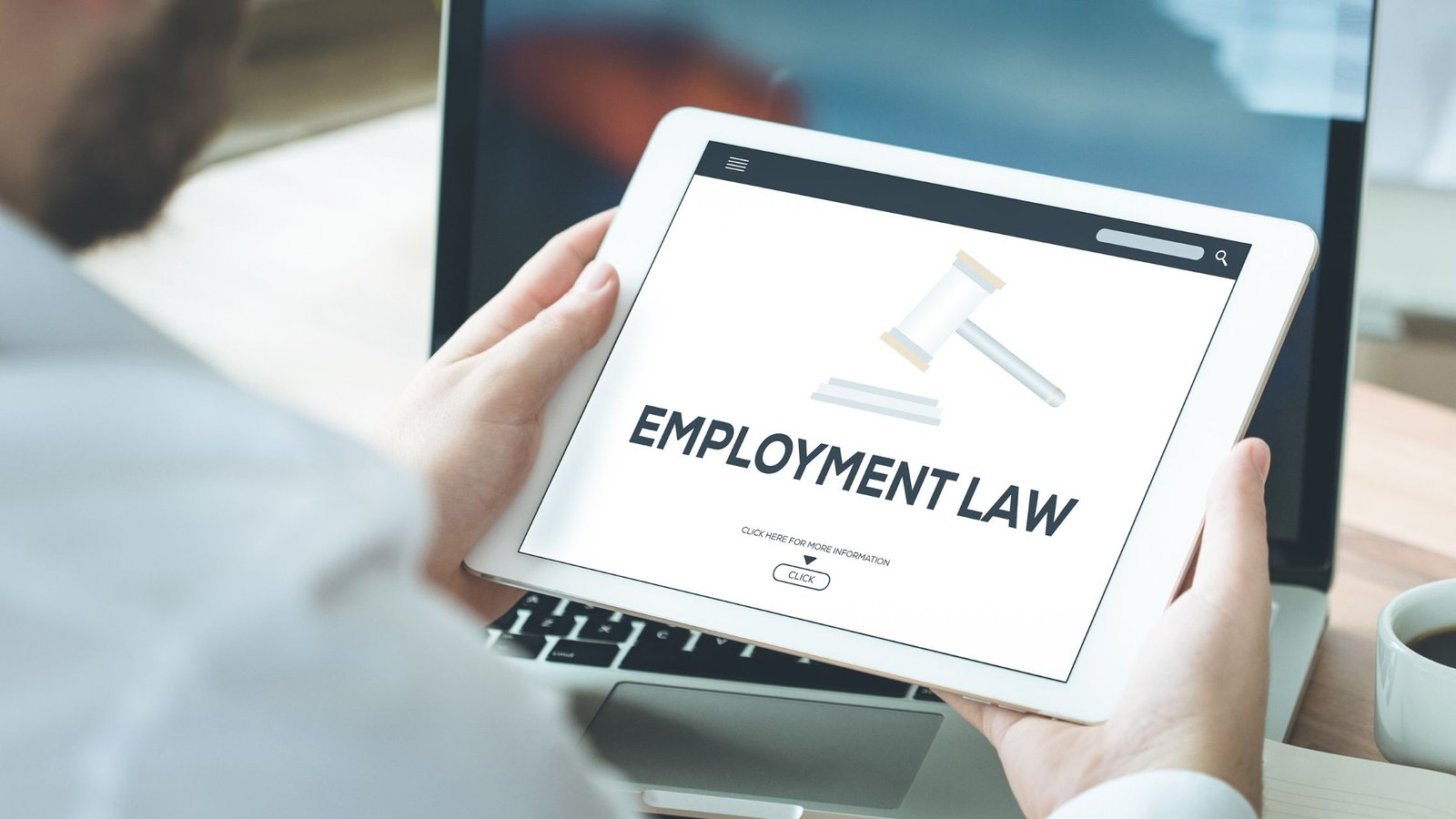 Business person looking at an employment law update on an ipad